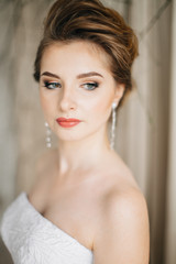 Portrait of bride with bouquet in Studio