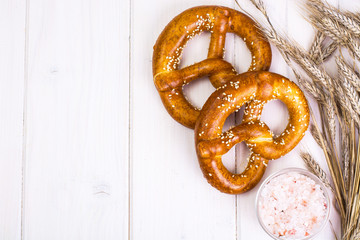 Bavarian pretzels with sesame seeds on white boards