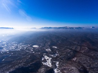 Fototapeta premium Aerial view of mountain village in the woods.