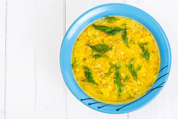 Pea soup with vegetables and dill on a white background