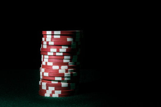 Stack Of Red Poker Chips On A Dark Background