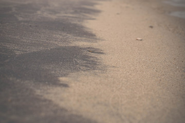 Black and white wet sand. Olchon island, Lake Baikal