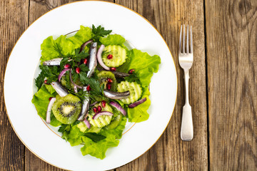 lettuce with anchovies and pomegranate seeds