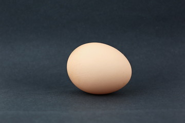 One fresh Egg, on a black background. Isolated.