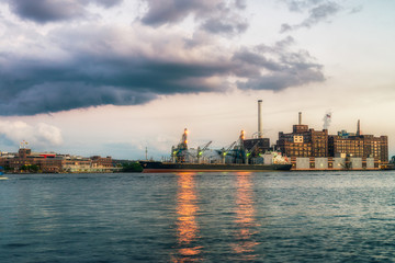 Baltimore, USA. Harbor and street view at sunset and deep colored sky. Splittoned, vivid image 