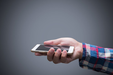 isolated man hand holding the phone with isolated screen. communication technology mobile phone high tech concept. isolated grey background