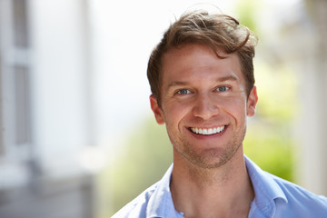 Outdoor Head And Shoulders Portrait Of Smiling Man