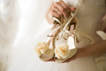 beautiful shoes in the hands of the bride