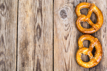 Fresh salty German bread: pretzels on a background of old boards