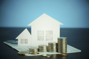 pile of money, coins  growing up, concept in business about loan, selling,finance and buying home, house