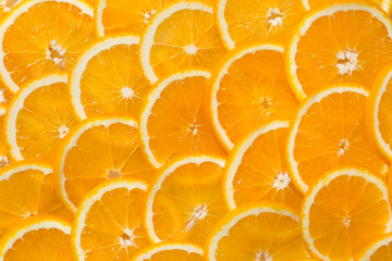 Bright orange background from slices of juicy Orange. Healthy fo