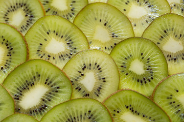Bright green background with slices of juicy kiwi. Healthy food