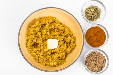 Lentil porridge with butter in a ceramic bowl on a white backgro