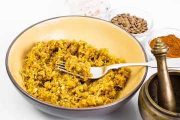 Lentil porridge with butter in a ceramic bowl on a white backgro