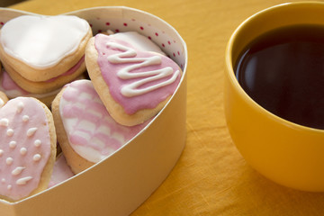 Cup of tea and cookies with frosting in shape of heart. Valentin