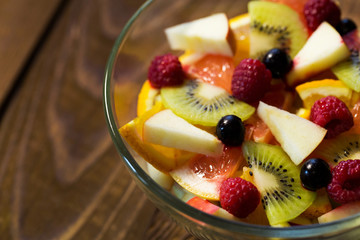 Delicious fruits salad in plate on table close-up