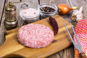 Minced meat for cooking hamburger on wooden board