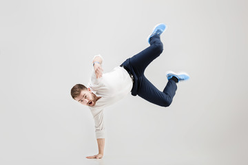 young happy businessman with beard in shirt break dancing on gre