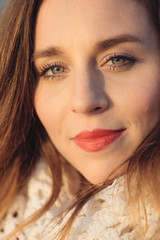 Obraz premium Sunny portrait of cute beautiful young woman smiling outdoor.