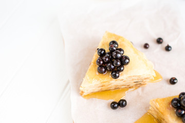 Homemade pancakes with berries and honey on a white background