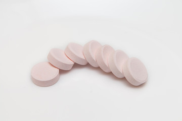 Vitamin C tablets pills on a white background