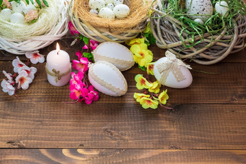 Obraz na płótnie Canvas Beautiful Easter eggs with flowers on the wooden background