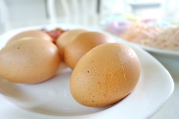 Crack boil egg on white plate, ready to eat