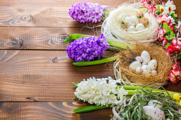 Obraz na płótnie Canvas Beautiful Easter eggs with flowers hyacinths on the wooden background
