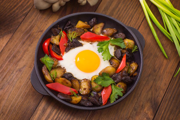 baked potato with mushrooms and egg. Wooden background. Top view