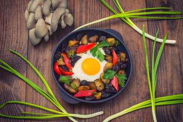 baked potato with mushrooms and egg. Wooden background. Top view