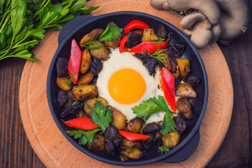 baked potato with mushrooms and egg. Wooden background. Top view