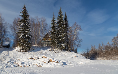House on shore of the river in wintertime