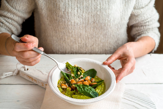 Woman Eating Avocado Cream With Almond And Spinach  Horizontal