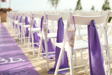 White wooden chairs for wedding ceremony. Flowers roses. Package