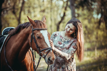 Fototapeta premium Young girl with a horse in the forest.