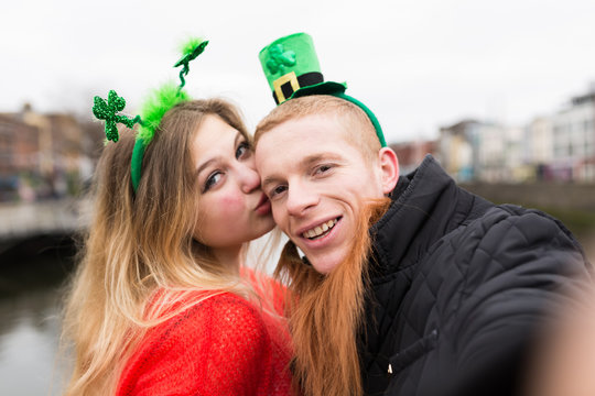Young Couple Taking a Photo with a Mobile Phone for St Patrick D