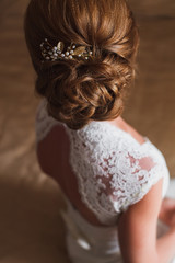 Wedding hairstyle. Bride. The brown-haired girl with curly hair,