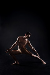 Flexible athlete stretching in the studio