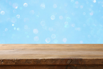 Empty table in front of blue glitter lights background