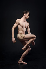 Fototapeta na wymiar Involved gymnast performing in the studio
