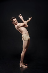 Flexible young ballet dancer performing in the studio