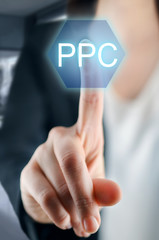 Businesswoman hand touching PPC button on virtual screen