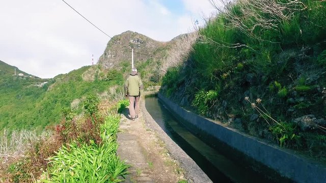 Tourists Walking on Hiking Pathway Levada Waterway