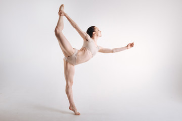 Slim ballet dancer standing on the tiptoe in the studio