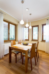 Cosy dining room surrounded by windows
