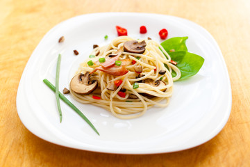 Pasta with mushrooms and vegetables on a plate
