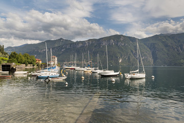 Boats in Bellagio on Lake Como with an alpine view