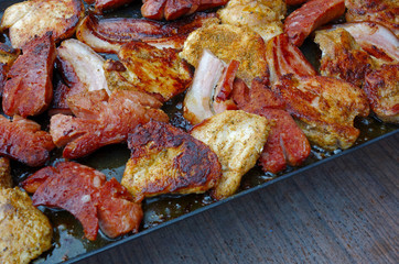 Different kinds of meat is baked on electric grill