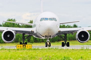 Fototapeta premium Airplane blue sky clouds flight airport grass green taxi