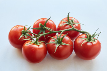 Fresh cherry tomatoes on white background